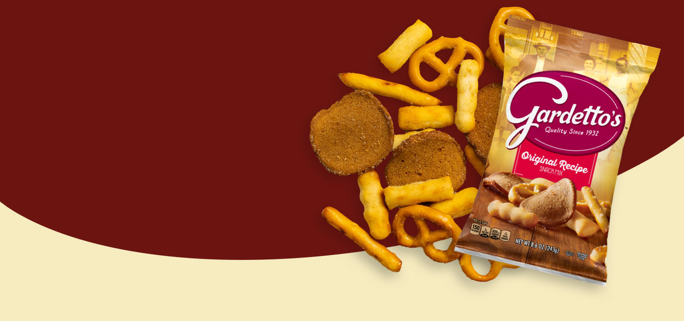 A front of pack with Gardetto's chips scattered on the side on a maroon and tan background